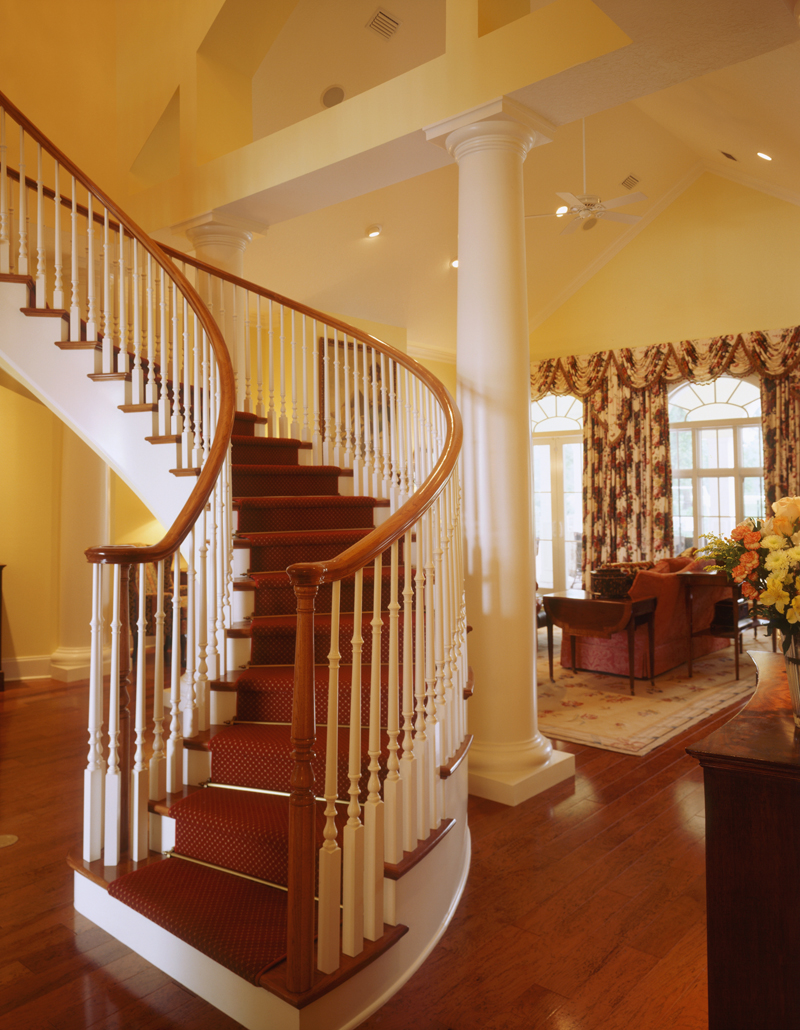 Curving staircase is graceful leading to the second floor.